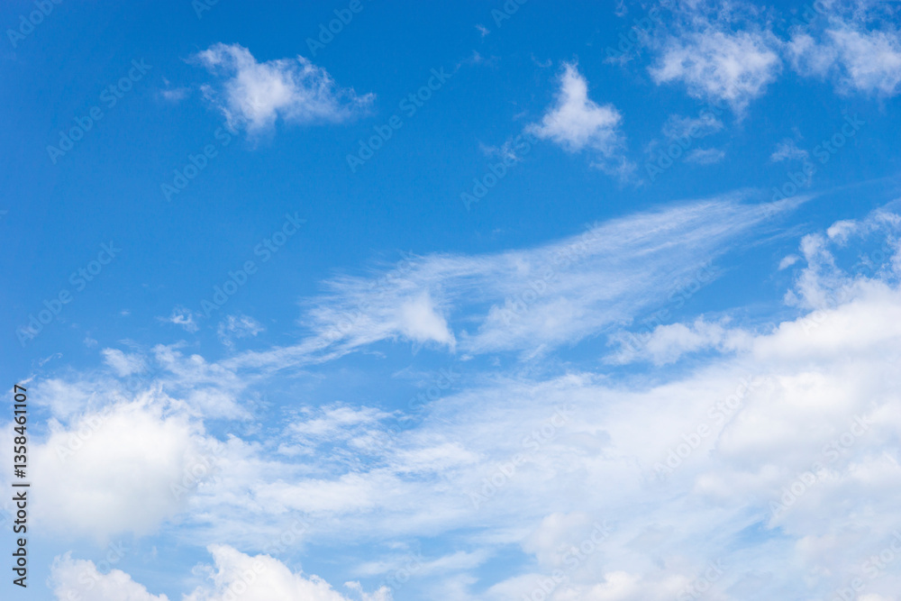 Clear blue sky with a few clouds. The sky is very bright and the clouds are scattered throughout, Beauty clear cloudy in sunshine Clear blue sky with a few clouds. The sky is very bright and the clouds are scattered throughout, Beauty clear cloudy in sunshine