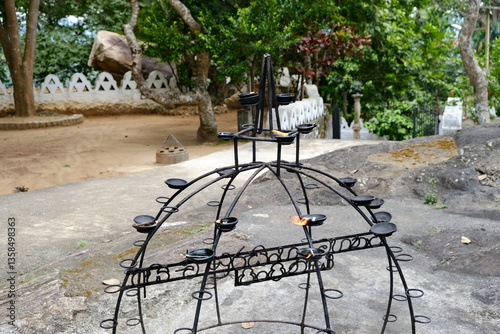 traditional clay oil lamps on a metal stand in a buddhist temple in sri lanka