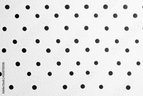 Small black dots printed on white paper background