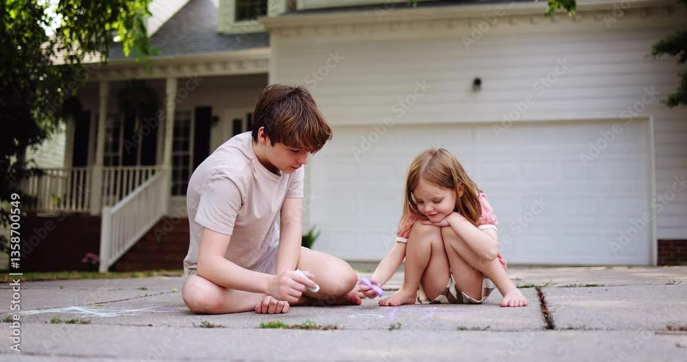 Brother and Sister Playing Tic Tac Toe with Sidewalk Chalk on Driveway in Front of Suburban Home – Warm Summer Afternoon, Real Family Moment