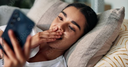 App, phone and surprise with woman on sofa in living room of home for alert or communication. Gossip, social media and wow of shocked person in apartment with gasp reaction to news or notification