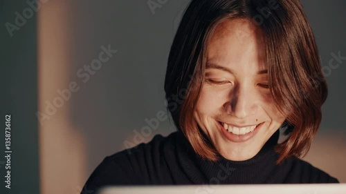 The Woman Smiling at Laptop