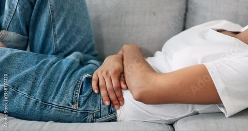 Home, hands and woman on sofa, period pain and gut health with stress in living room. Closeup, apartment and person on couch, menstruation and digestion with constipation, pms and menstrual cycle