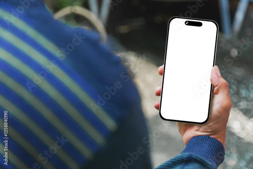 Image of man's hand holding a smartphone with white space on the mobile screen for inserting text or advertising banner.