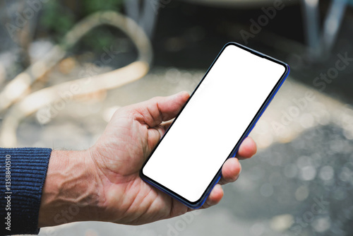 Image of man's hand holding a smartphone with white space on the mobile screen for inserting text or advertising banner.