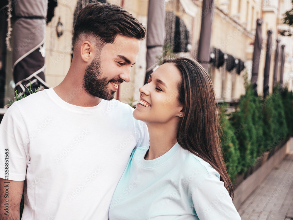 Naklejka premium Smiling beautiful woman and her handsome boyfriend. Woman in casual summer jeans clothes. Happy cheerful family. Female having fun. Sexy couple posing in the street at sunny day . In sunglasses