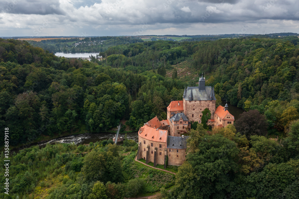 Aerial view of medieval Kriebstein Castle, perched on rocky cliff on Zschopau River. One of most picturesque castles in Germany, known for its Gothic architecture Aerial view of medieval Kriebstein Castle, perched on rocky cliff on Zschopau River. One of most picturesque castles in Germany, known for its Gothic architecture