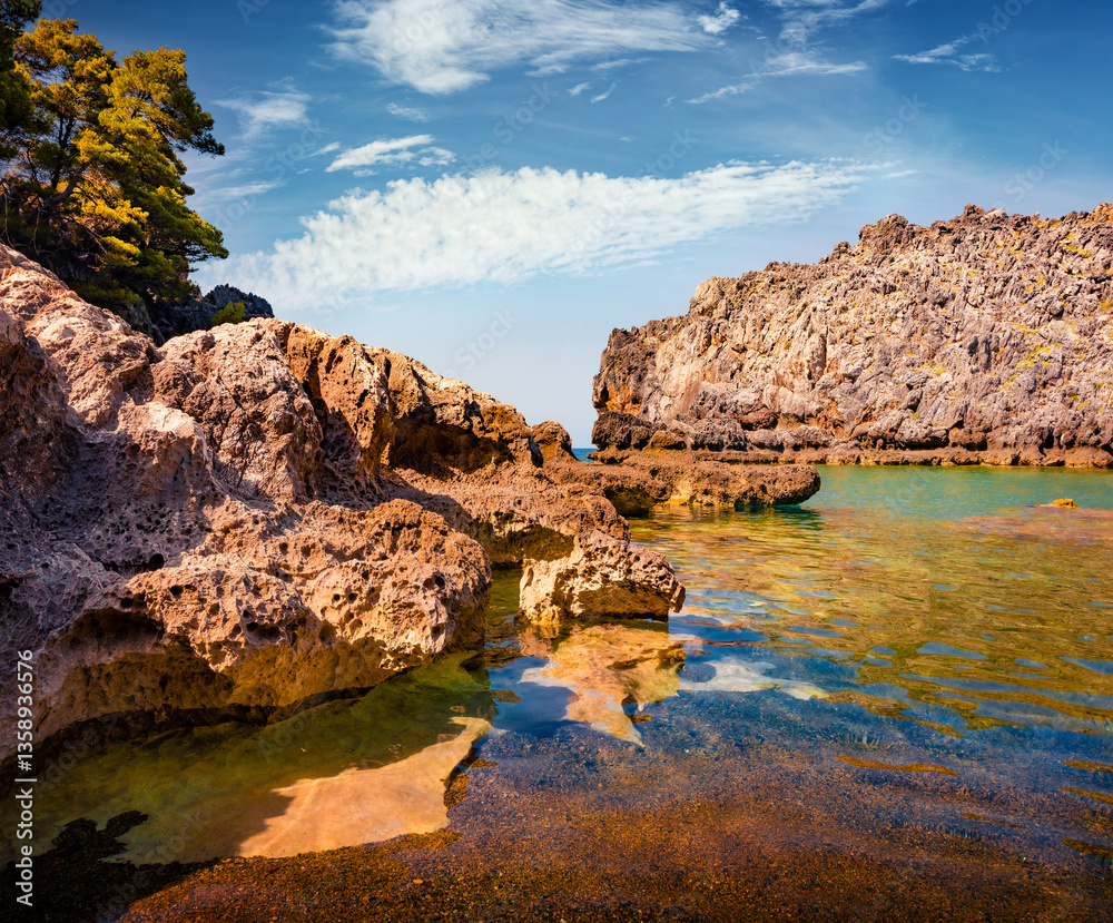 Colorful morning view of Stelolinari beach. Bright outdoor scene of Euboea island, Greece. Calm summer seascape of Myrtoan Sea. Beauty of nature concept background.