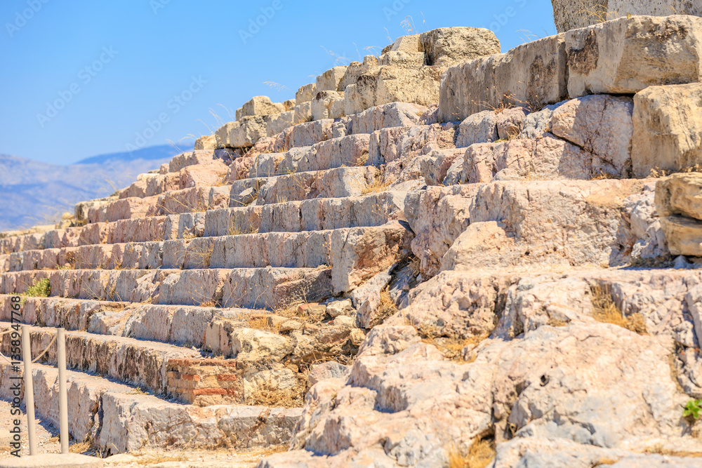 A stone wall with a series of steps leading up to it, Acropolis in Athens A stone wall with a series of steps leading up to it, Acropolis in Athens