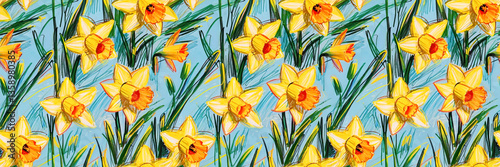 Spring seamless botanical pattern of yellow daffodils with orange centers on blue background