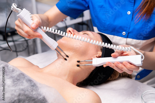 Close-up Of A Young Woman Lying With Electrodes On Her neck