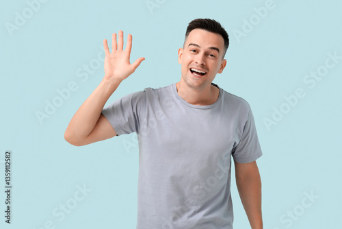 Handsome man waving hand on...