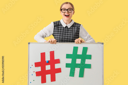 Young teacher holding white...