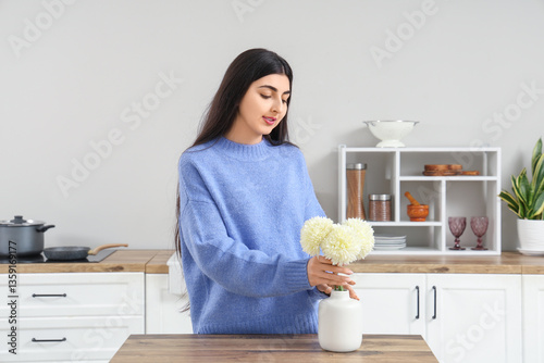 Pretty young woman putting ...