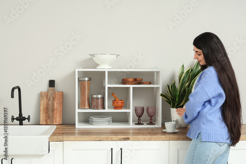 Pretty young woman pouring ...