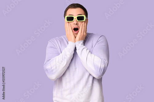 Shocked young man in glasse...