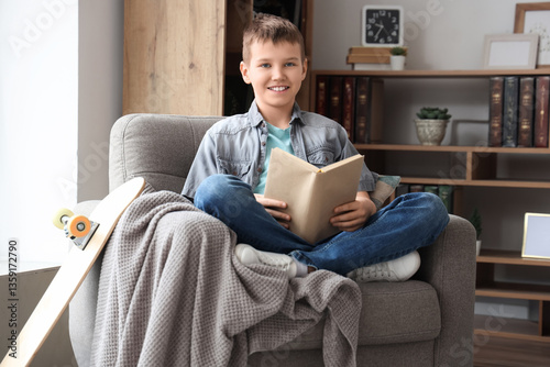 Teenage boy reading book on...