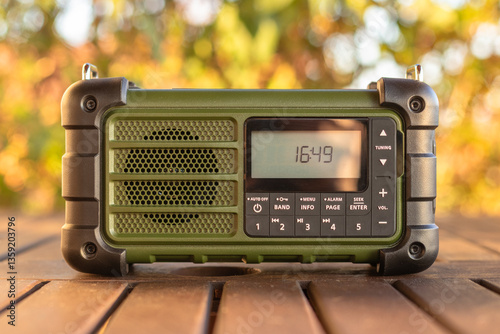 Modern Portable Green Radio on Wooden Table Outdoor Setting