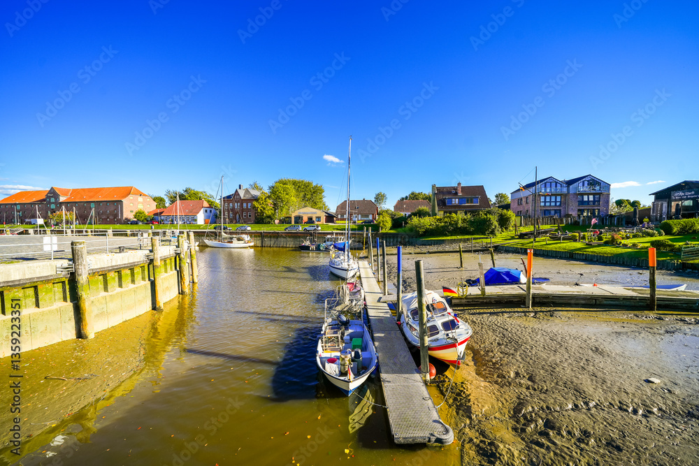 Naklejka premium Surroundings at the harbor in the town of Tönning. Landscape in North Frisia with a view of the Eider River. 