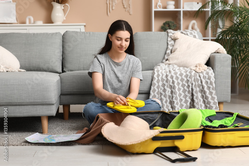 Young woman packing flip-fl...