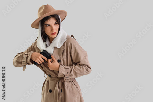 Female spy with gun on ligh...