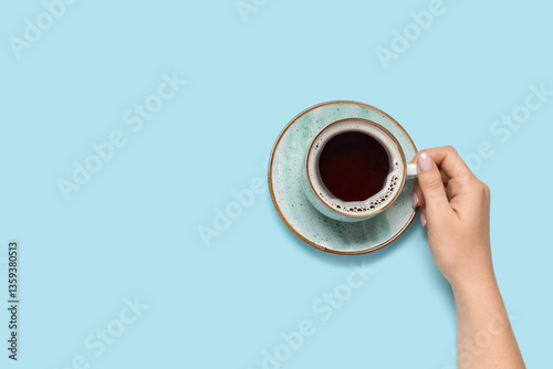 Female hand with cup of cof...