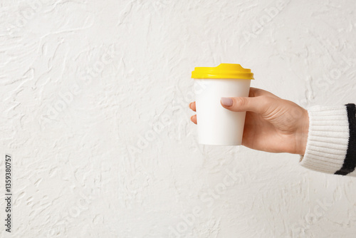 Female hand holding paper c...