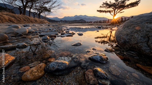 Sunset reflection on tranquil river stones serene landscape nature scene rocky environment wide-angle view