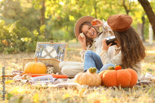 Cute girls with pumpkins ta...