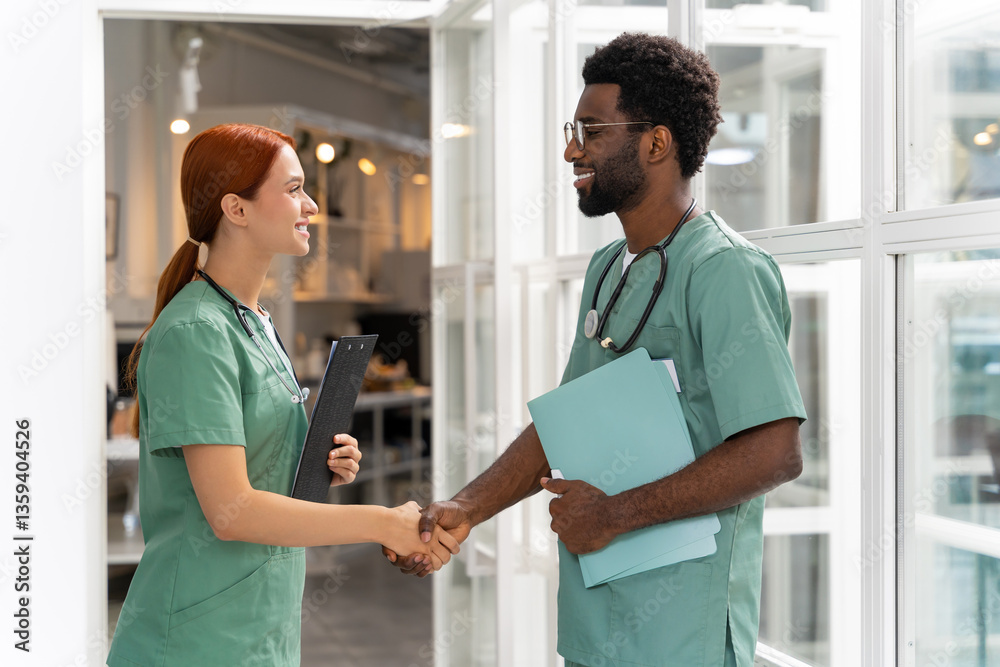 Fototapeta premium Hospital staff engaged in professional discussion while walking in medical hall