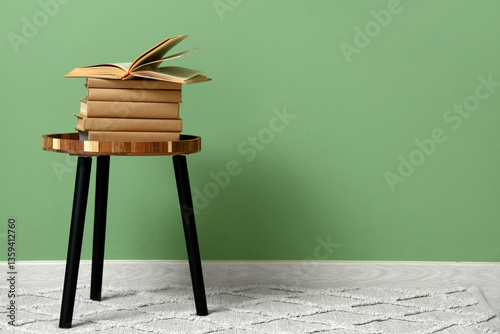 education and learning concept, stack of vintage books on a small wooden tabl...