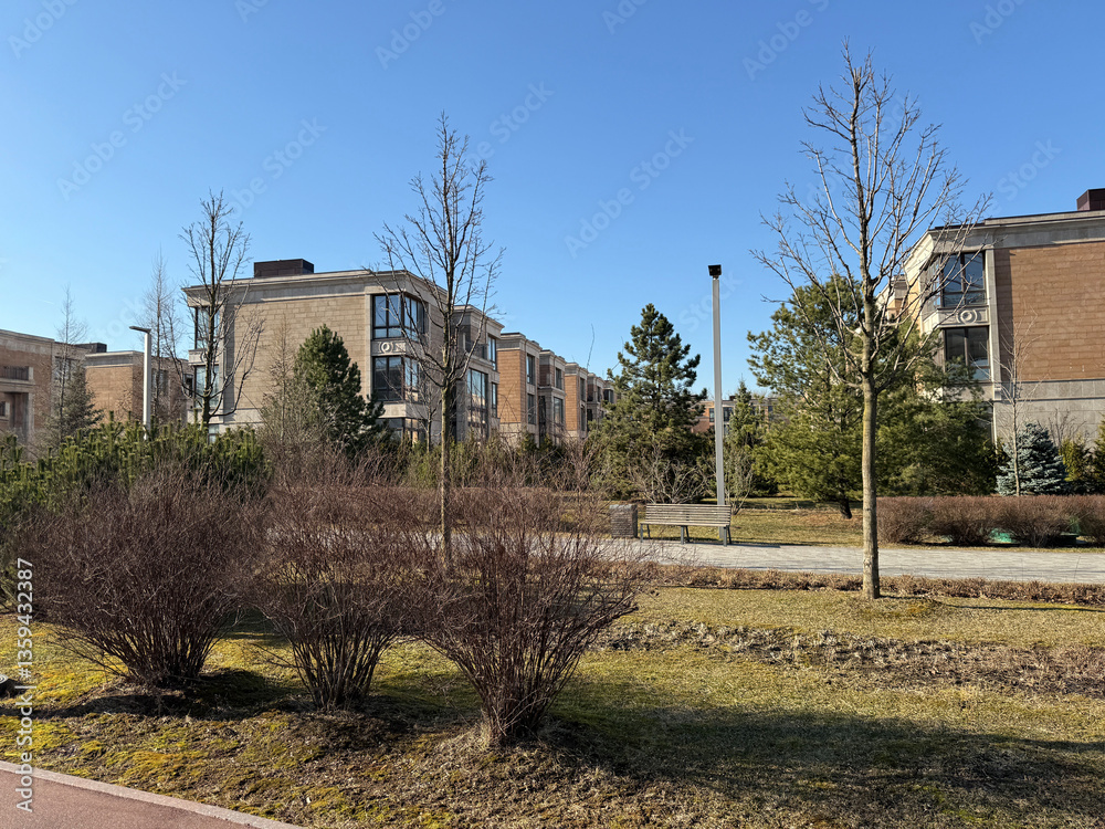 modern, multi-story residential buildings with large windows and beige stone facades. The architecture is elegant and contemporary. The weather is clear and sunny, with a bright blue sky modern, multi-story residential buildings with large windows and beige stone facades. The architecture is elegant and contemporary. The weather is clear and sunny, with a bright blue sky
