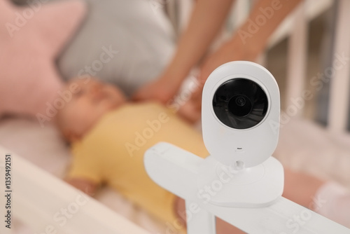 Baby monitor on crib agains...