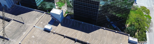 Panorama aerial view glass office building with multistorey car park parking garage structure in Westchase business district, western Houston, Texas, rooftop structure space-efficient solution