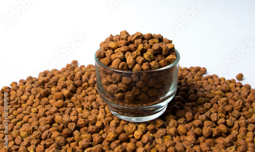 Fotografie Organic Brown Chickpeas in a Glass Bowl Isolated on a white background