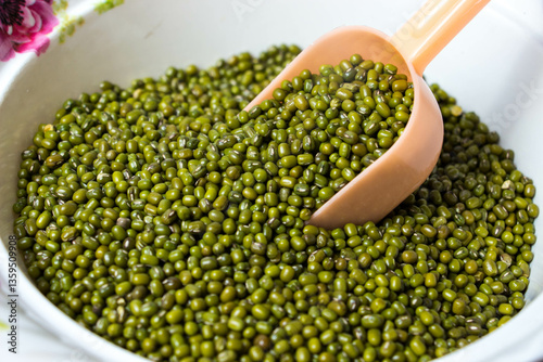 Fototapeta Front view of Green Moong Dal beans in a scoop