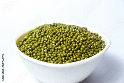 Fotografie Green Moong Dal beans in a White Bowl Isolated on a white background