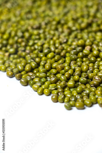 Fototapeta Vertical shot of Green Moong Dal beans Isolated on a white background