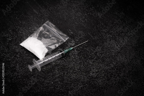 Syringe with drugs dose on black background. powder in plastic bag. Drugs concept on dark place. addiction and bad habits. Heroin narcotic crime. Danger addict problem criminal