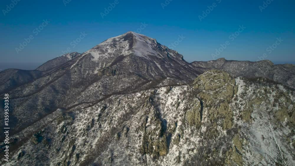 Aerial view of a mountain range with high cliffs. Landscape and nature of the North Caucasus Aerial view of a mountain range with high cliffs. Landscape and nature of the North Caucasus