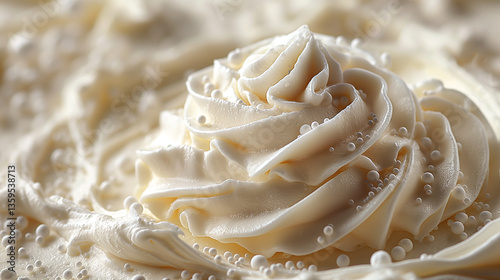 Close-up of a beautifully crafted swirl of cream, showcasing smooth textures and delicate bead details.