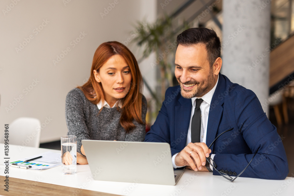 Two Professionals Discussing Project Plans in a Modern Office Setting Two Professionals Discussing Project Plans in a Modern Office Setting