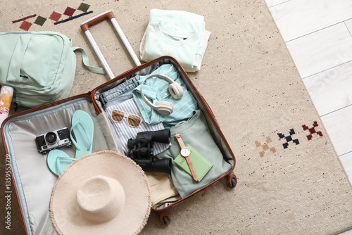 Unpacked suitcase with clot...