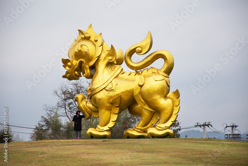 Gold Singha statue on hill in Singha Park at Chiangrai city in Chiang Rai, Thailand photo