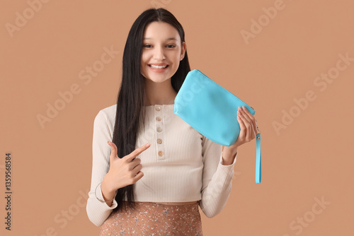 Teenage girl pointing at co...