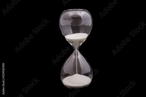 Elegant hourglass with flowing sand against a dark background showcasing time