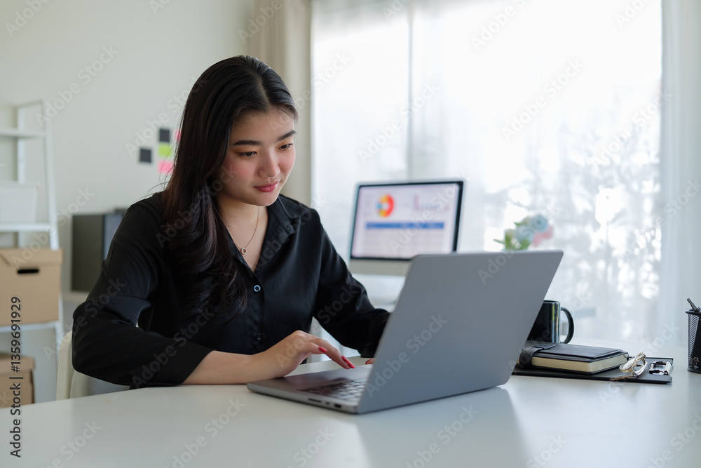 Focused businesswoman working on data analysis, using laptop in a modern office. Focused businesswoman working on data analysis, using laptop in a modern office.