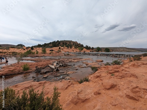 Scenic View of Gunlock Falls with Flowing Water and Red Rock Landscape in Utah. photo