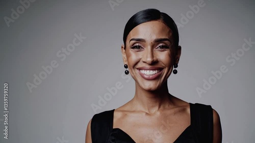 Smiling Latin woman in her 30s or 40s, beautiful glamour, makeup and wellness, white background and light