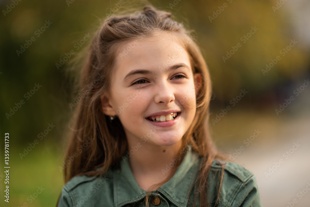 Portrait of a happy child girl outside.